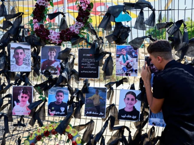 a person mourns as he embraces the picture of his loved one killed at a soccer pitch by a rocket israel says was fired from lebanon in majdal shams a druze village in the israeli occupied golan heights july 29 2024 photo reuters